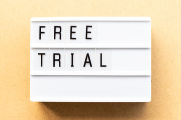 Light box with word free trial on wood background