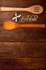 Restaurant menu. Top view of woodboard menu laying on the rustic wooden desk with accessories.