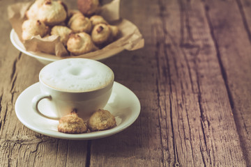 Obraz na płótnie Canvas Cup of Coffee and Homemade Coconut Cookies on Old Wooden Background Horizontal Copy Space Tasty Coconut Dessert and Hot Drink Homemade Coconut Cookies Rustic Morning Breakfast