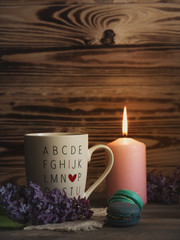 macaroons on wood table with cup and flowers