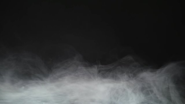 Smoke background. Abstract smoke cloud. Smoke in slow motion on black background. White smoke slowly floating through space against black background. Smoke effect. Fog effect. Smoke machine