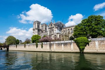 Fototapeta na wymiar View on the Notre Dame de Paris Cathedral after fire from the Seine river bank during sunny day. Paris 2019.