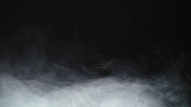 Smoke background. Abstract smoke cloud. Smoke in slow motion on black background. White smoke slowly floating through space against black background. Smoke effect. Fog effect. Smoke machine