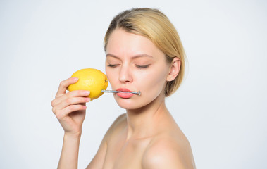 lemon battery. woman with hobnail at lemon. vitamin diet food. skincare. healthy skin. energy and...