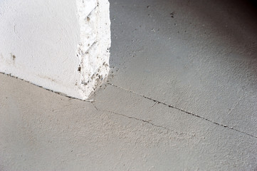Screed Failure. Cement screed cracked. Gray stone background. Problems can involve cracking,...