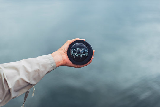 Nautical compass in female's hand