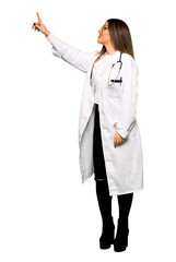 Full body of Young doctor woman pointing away