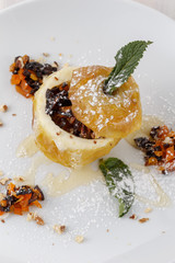 baked apple on a plate sprinkled with powdered sugar