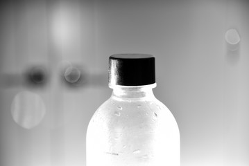 Clear plastic water bottle with black cap closeup