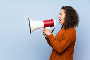 Dominican woman with curly hair shouting through a megaphone