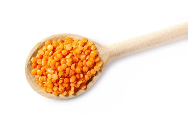 Red lentils with wooden spoon isolated on white background, clipping path, top view