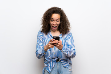 Dominican woman with striped shirt surprised with a mobile