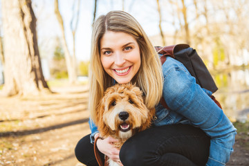 Happy Labradoodle Dog and woman outside at the park