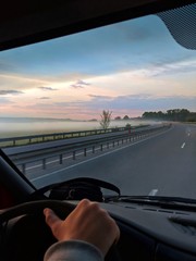 driving on highway at sunset