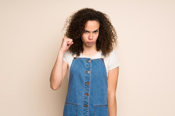 Dominican woman with overalls with angry gesture