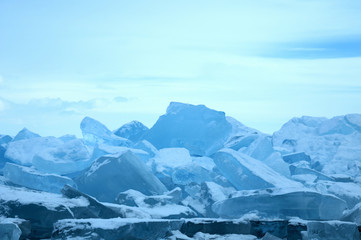 Fototapeta na wymiar Sun rays are refracted by the transparent ice of Lake Baikal. crystal clear ice fragments — hummocks