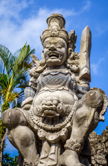 Fototapeta na wymiar Gard statue on a temple entrance door, Ubud, Bali, Indonesia