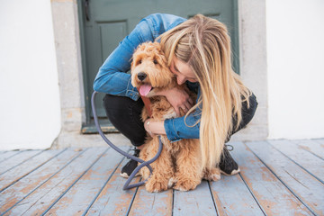 Labradoodle Dog and woman outside on balcony