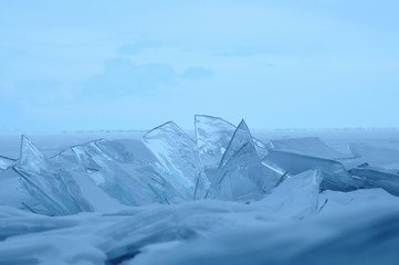 Sun rays are refracted by the transparent ice of Lake Baikal. crystal clear ice fragments — hummocks