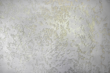 Paper wallpaper with a gold pattern. Yellow drawing on the wall.