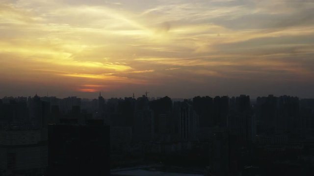Shanghai hazy sunset timelapse in residential area apartment buildings.Time lapse of smoggy Shanghai sunset skyline from residential area with many apartment buildings.
