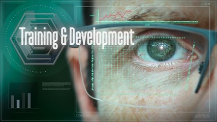 A close up of a businessman eye controlling a futuristic computer system with a Training and development Business concept.