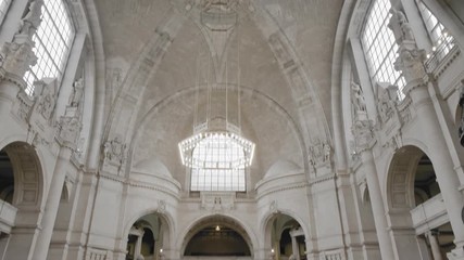 HANOVER, GERMANY - October 2018: Hall of the municipality. In the center is a huge chandelier, white walls of brick. The concept of free access to the town hall. Medieval castle. Slow Motion Vertical - Powered by Adobe