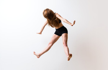 Fototapeta na wymiar Young dance girl over isolated white wall.
