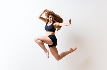 Young dance girl over isolated white wall.