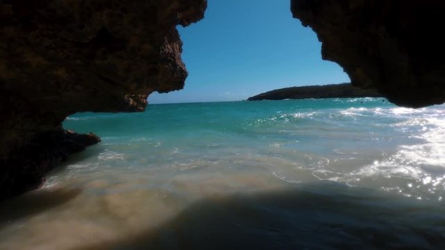 A secluded secret ocean cave during low tide located on Navio beach or Playa Navio in Vieques Puerto Rico on a clear warm spring day.