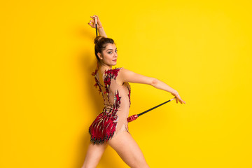 Girl doing rhythmic gymnastics with maces.