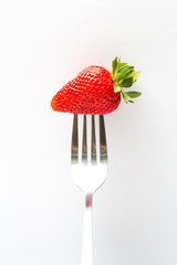 strawberry on fork isolated on white