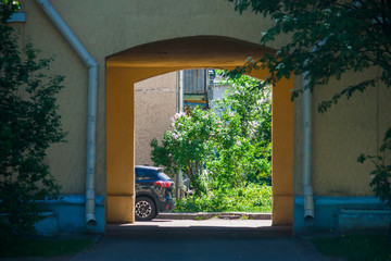 The passage through the arch gives you the opportunity to be on the sunny side of the street. Laz on the sunny bright side of the city with flowering lilac bushes.