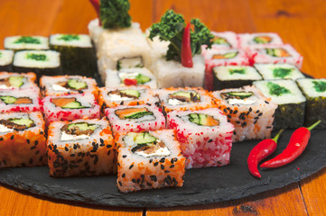 spicy japanese rolls set laid out on a graphite plate