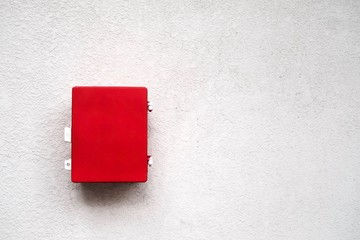 The red emergency box on white wall
