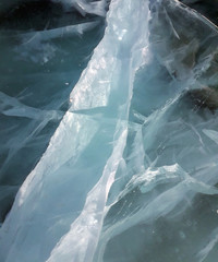 Sun rays are refracted by the transparent ice of Lake Baikal. cracks at different depths create a bizarre web