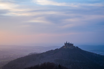 Fototapeta na wymiar Germany, Hohenzollern castle in misty sunset atmosphere in springtime evening