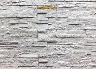 wall of natural stone blocks of gray and sand color
