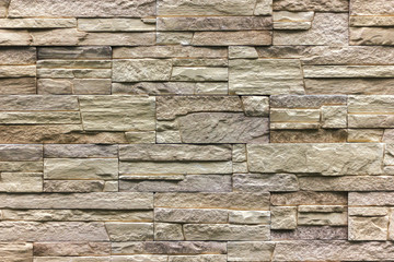 wall of natural stone blocks of gray and sand color