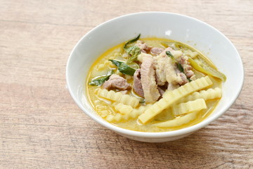spicy boiled chicken with coconut shoot in curry on bowl