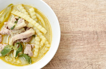 spicy boiled chicken with coconut shoot in curry on bowl