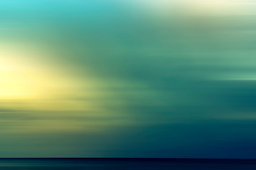 Fototapeta premium Abstract summer background with the setting sun over the sea.