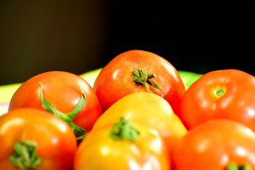 Beautiful red tomatoes in close up view on table
