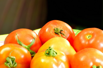 Beautiful red tomatoes in close up view on table