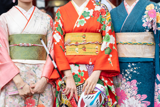 Young girl wearing Japanese kimono standing in front of Sensoji Temple in Tokyo, Japan. Kimono is a Japanese traditional garment. The word "kimono", which actually means a "thing to wear"