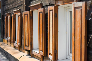 Fototapeta na wymiar Wooden brown shutters and wooden windows.