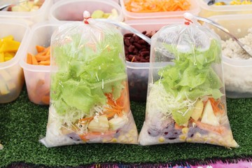 Salad fresh vegetables with dressing in market
