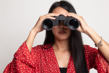 Young Asian woman with binoculars.