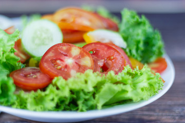 Close up A green salad is a dish consisting of a mixture of small usually Green leafy vegetables with tomato 