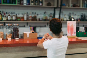 young attractive woman makes an order in a cafe